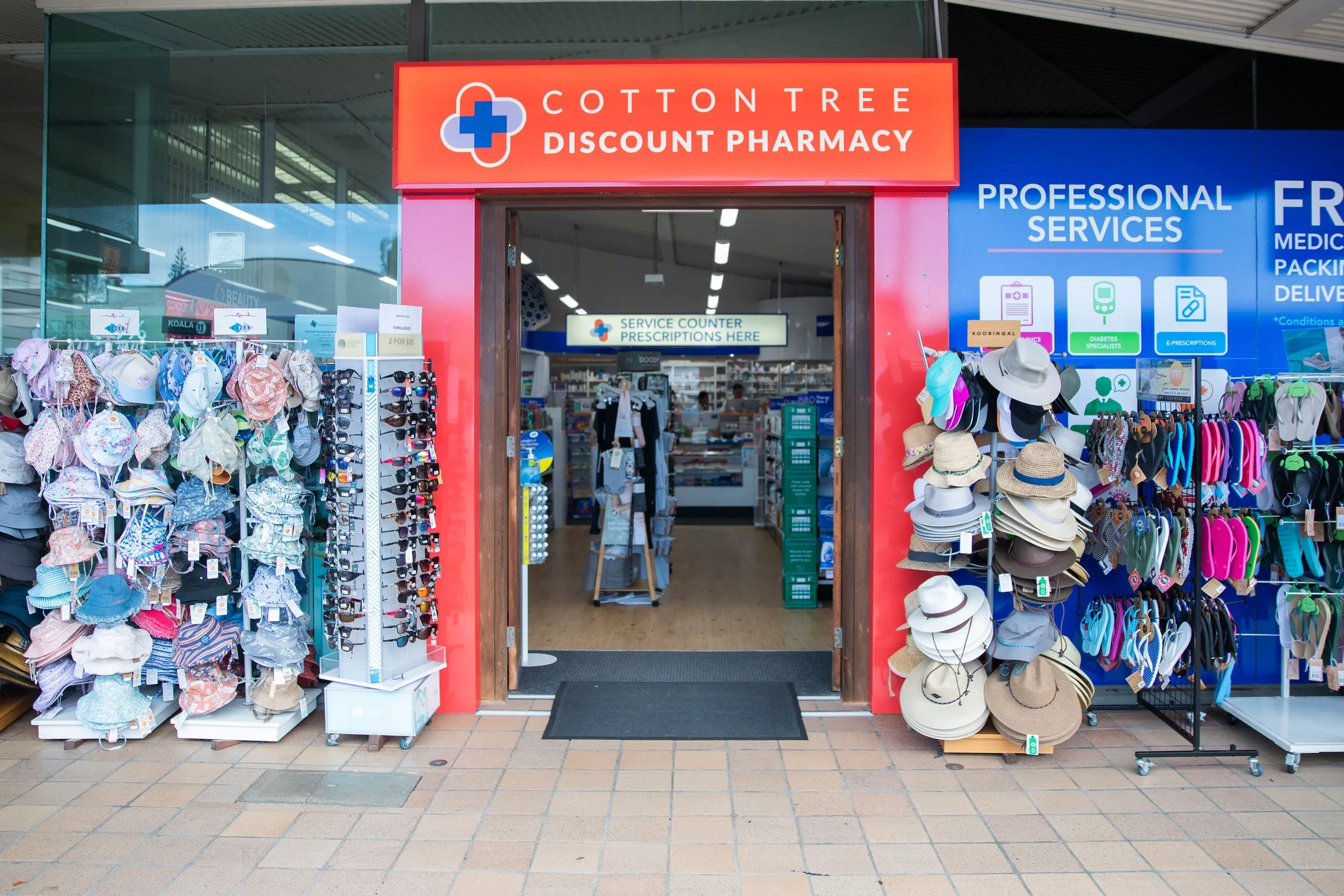 Looking down the aisle to the prescription counter at Cotton Tree Discount Pharmacy